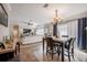 Cozy dining room is conveniently positioned between the living room and kitchen with a chandelier and big windows at 4010 Paw Paw Trl, Lake Wales, FL 33898