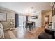 Well-lit dining room with a modern chandelier, sliding glass doors, and comfortable seating, ideal for entertaining guests at 4010 Paw Paw Trl, Lake Wales, FL 33898