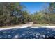 Private driveway leading to a secluded property, surrounded by lush trees and natural beauty at 4010 Paw Paw Trl, Lake Wales, FL 33898