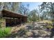 Picturesque outdoor area with a shed and beautiful trees at 4010 Paw Paw Trl, Lake Wales, FL 33898
