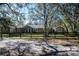 Inviting single-story home featuring a well-maintained lawn and classic wooden fencing at 4010 Paw Paw Trl, Lake Wales, FL 33898