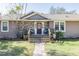 Inviting front porch with stone accents, charming decor, and a welcoming entrance at 4010 Paw Paw Trl, Lake Wales, FL 33898