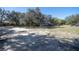 Spacious front yard boasting verdant scenery and privacy, perfect for outdoor enjoyment at 4010 Paw Paw Trl, Lake Wales, FL 33898