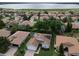 Aerial view of the home showcasing solar panels, landscaping, and neighborhood lake views at 4063 Birkdale Dr, Lake Wales, FL 33859