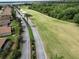 Scenic aerial view of the community with golf course, lush landscaping, and residential street at 4063 Birkdale Dr, Lake Wales, FL 33859