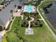 Aerial view of community amenities including a pool, gardens, chess and a lake at 4063 Birkdale Dr, Lake Wales, FL 33859