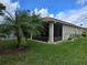 Beautiful backyard features a screen lanai, lush green lawn, and tropical landscaping at 4063 Birkdale Dr, Lake Wales, FL 33859