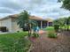 The backyard offers open patio space with blue Adirondack chairs and mature landscaping at 4063 Birkdale Dr, Lake Wales, FL 33859