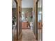 Bathroom view with mirrors, cabinetry, sinks, and neutral leafy patterned wall paper at 4063 Birkdale Dr, Lake Wales, FL 33859
