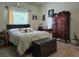 Cozy bedroom with natural light, wooden furniture, and a comfortable bed at 4063 Birkdale Dr, Lake Wales, FL 33859
