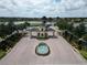 Lake Ashton community entrance featuring a fountain, security gate, and lush landscaping at 4063 Birkdale Dr, Lake Wales, FL 33859