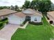 Charming home featuring brick walkway, well-manicured lawn, and attached two-car garage at 4063 Birkdale Dr, Lake Wales, FL 33859