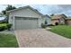 Charming home with a brick driveway, lush lawn, and well-maintained landscaping at 4063 Birkdale Dr, Lake Wales, FL 33859