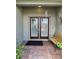 Inviting front porch with double doors, brick flooring, and a cozy bench at 4063 Birkdale Dr, Lake Wales, FL 33859
