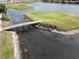 Picturesque island green on the golf course with a wooden bridge and water features at 4063 Birkdale Dr, Lake Wales, FL 33859