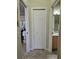 Hallway view with storage closet, leading to bathroom with vanity and mirror at 4063 Birkdale Dr, Lake Wales, FL 33859