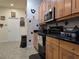 Well-lit kitchen with wooden cabinets, stainless steel appliances, and storage shelves at 4063 Birkdale Dr, Lake Wales, FL 33859