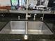 Close-up of a stainless steel double kitchen sink with granite countertops at 4063 Birkdale Dr, Lake Wales, FL 33859