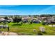 Aerial view of lakeside property with private docks, sheds, a pool and a serene waterway at 4099 Island Lakes Dr, Winter Haven, FL 33881