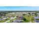 Aerial view of neighborhood highlighting proximity to lake with docks and a large waterway at 4099 Island Lakes Dr, Winter Haven, FL 33881