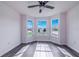 Sun-filled bedroom with three large windows and gray flooring offers plenty of natural light at 4099 Island Lakes Dr, Winter Haven, FL 33881
