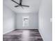Simple bedroom with gray floors, white walls and trim, a ceiling fan, and a window at 4099 Island Lakes Dr, Winter Haven, FL 33881
