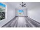 Spacious bedroom featuring neutral walls, natural lighting, and dark flooring at 4099 Island Lakes Dr, Winter Haven, FL 33881