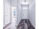 Bright entrance hallway boasting dark hardwood flooring and white doors at 4099 Island Lakes Dr, Winter Haven, FL 33881