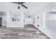 Spacious living room with gray flooring adjacent to the kitchen, and lots of natural light at 4099 Island Lakes Dr, Winter Haven, FL 33881