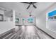 Living room with gray flooring and a view of the outdoors through windows and a sliding glass door at 4099 Island Lakes Dr, Winter Haven, FL 33881