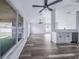 Open-concept living room bathed in natural light, showcasing the wood-look flooring and view to the backyard at 4099 Island Lakes Dr, Winter Haven, FL 33881