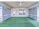 Enclosed patio with artificial turf, ceiling fan, and privacy screens, great for enjoying the outdoors at 4099 Island Lakes Dr, Winter Haven, FL 33881