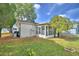 Backyard view featuring lawn, exterior of home, and mature trees at 4229 Nandina St, Lake Wales, FL 33898