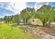 A spacious backyard exhibiting the home's rear exterior and lush greenery at 4229 Nandina St, Lake Wales, FL 33898
