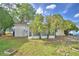 Spacious backyard showcasing mature landscaping and the home's exterior at 4229 Nandina St, Lake Wales, FL 33898