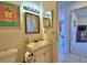 A well-lit bathroom showcasing a vanity, mirror, and view into the bedroom at 4229 Nandina St, Lake Wales, FL 33898