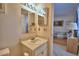 Bright bathroom features a vanity with integrated sink and a well-lit mirror at 4229 Nandina St, Lake Wales, FL 33898