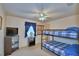 Bright bedroom with a bunk bed, ceiling fan, and natural light from the window at 4229 Nandina St, Lake Wales, FL 33898