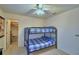 Bedroom featuring bunkbeds, a ceiling fan, a closet, and a small TV with shelves at 4229 Nandina St, Lake Wales, FL 33898