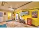 Well-lit garage with storage, and a bright yellow painted walls at 4229 Nandina St, Lake Wales, FL 33898