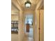 Hallway view with multiple doorways, tile floor, and view into bedroom at 4229 Nandina St, Lake Wales, FL 33898
