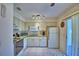 Charming kitchen with tile flooring, white appliances, and ample cabinet space at 4229 Nandina St, Lake Wales, FL 33898