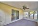 Enclosed sunroom featuring sliding glass doors, a ceiling fan, and natural light at 4229 Nandina St, Lake Wales, FL 33898