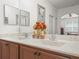 Bathroom with double sinks, a large vanity, and a decorative mirror at 4313 Heath Land Ln, Lake Wales, FL 33859
