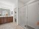 Bathroom featuring a shower with glass doors, a vanity with double sinks, and modern lighting at 4313 Heath Land Ln, Lake Wales, FL 33859