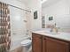 Bathroom with a shower-tub, vanity with storage, and a matching floral patterned shower curtain at 4313 Heath Land Ln, Lake Wales, FL 33859