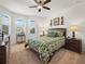 Bedroom featuring a queen bed with leaf patterned comforter, ceiling fan, and bright natural light at 4313 Heath Land Ln, Lake Wales, FL 33859