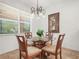 Cozy breakfast nook with a round glass table, chandelier, and bright natural light at 4313 Heath Land Ln, Lake Wales, FL 33859