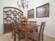 Elegant dining room with a wooden table, six chairs, and stylish decor at 4313 Heath Land Ln, Lake Wales, FL 33859