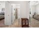 A hallway view leading to a bathroom and living room, showcasing tile flooring and open spaces at 4313 Heath Land Ln, Lake Wales, FL 33859